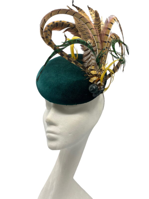 Stunning green velvet headpiece with feather detail.